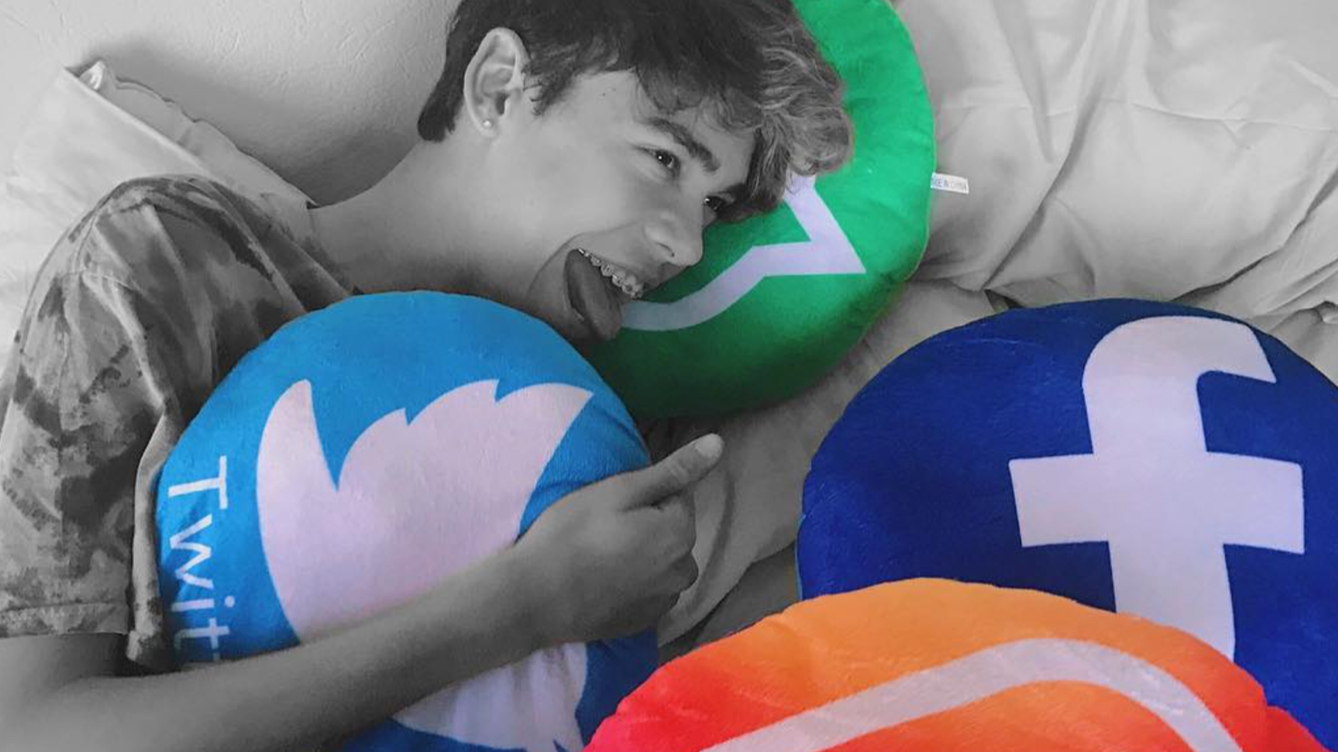 Jayden holds social media themed cushions