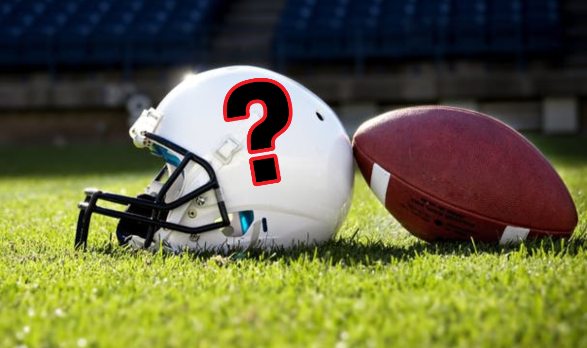 Football helmet on grass with football and question mark
