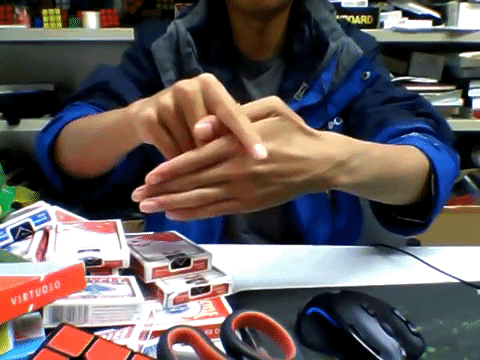 This a GIF of a magician performing the 'missing finger' trick